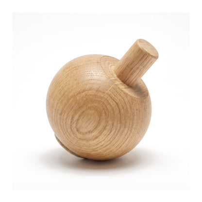 Close detail of a solid oak Bordesley ball foot on white, tipped to show the integral 20mm turned dowel spigot and unbroken grain