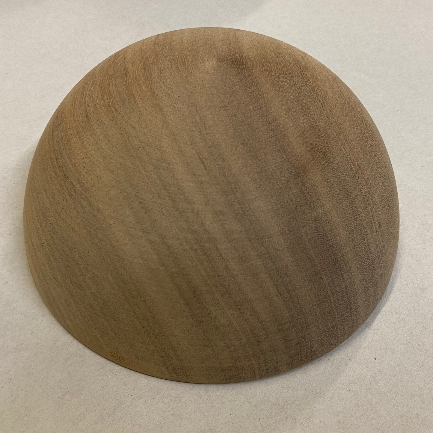 Wooden sphere on a light gray background