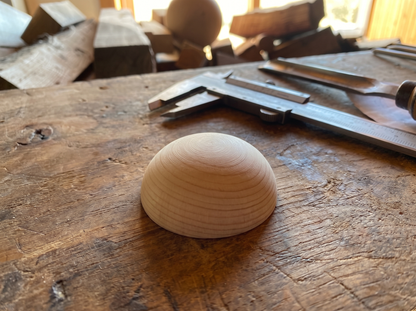 3 cm pine wooden hemisphere, hand-turned, on the workshop bench