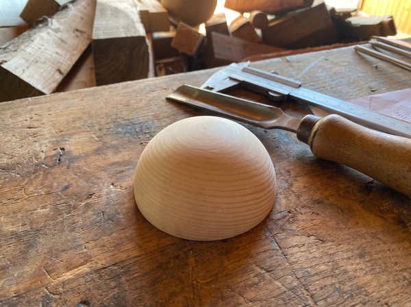 4 cm pine wooden hemisphere, hand-turned, on the workshop bench