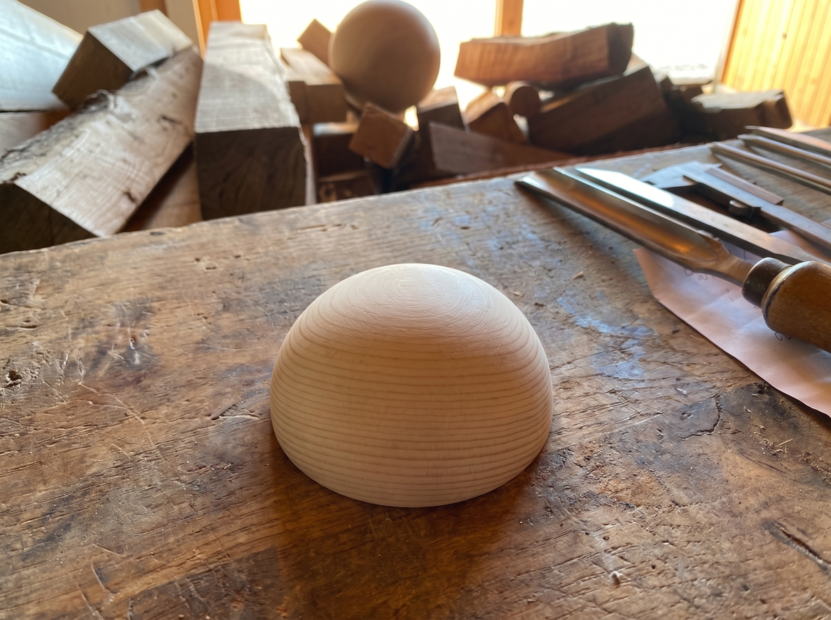 5 cm pine wooden hemisphere, hand-turned, on the workshop bench