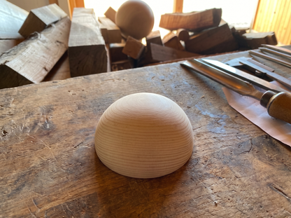 5 cm pine wooden hemisphere, hand-turned, on the workshop bench
