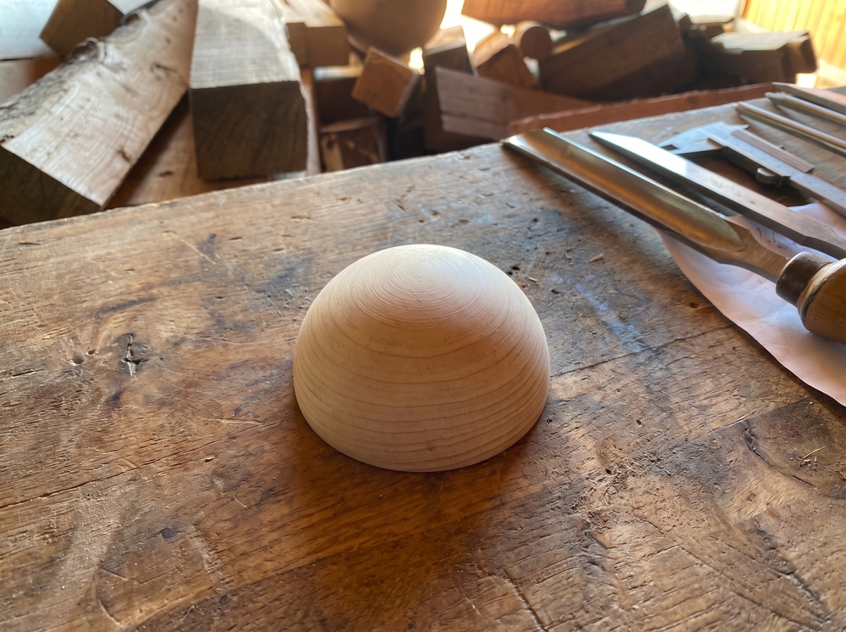 6 cm pine wooden hemisphere, hand-turned, on the workshop bench