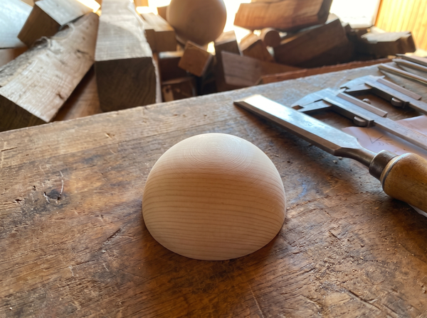 7 cm pine wooden hemisphere, hand-turned, on the workshop bench