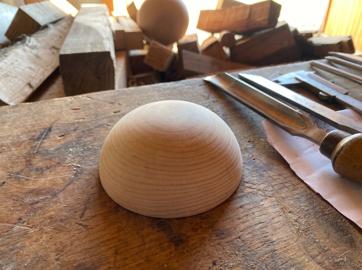 8 cm pine wooden hemisphere, hand-turned, on the workshop bench