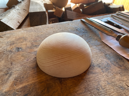 9 cm pine wooden hemisphere, hand-turned, on the workshop bench