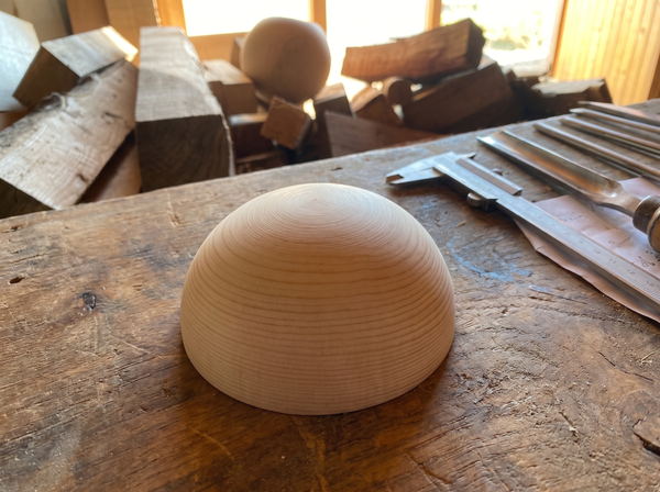 11 cm pine wooden hemisphere, hand-turned, on the workshop bench