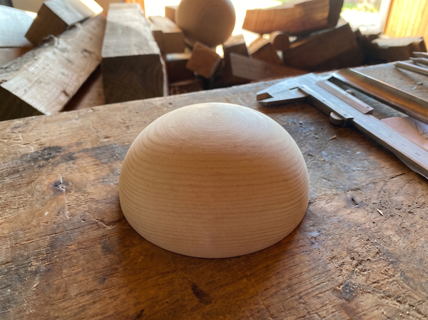 12 cm pine wooden hemisphere, hand-turned, on the workshop bench