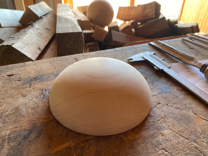 14 cm pine wooden hemisphere, hand-turned, on the workshop bench