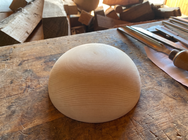 17 cm pine wooden hemisphere, hand-turned, on the workshop bench