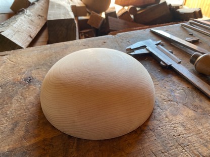 18 cm pine wooden hemisphere, hand-turned, on the workshop bench