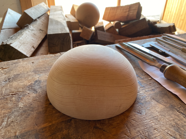 19 cm pine wooden hemisphere, hand-turned, on the workshop bench
