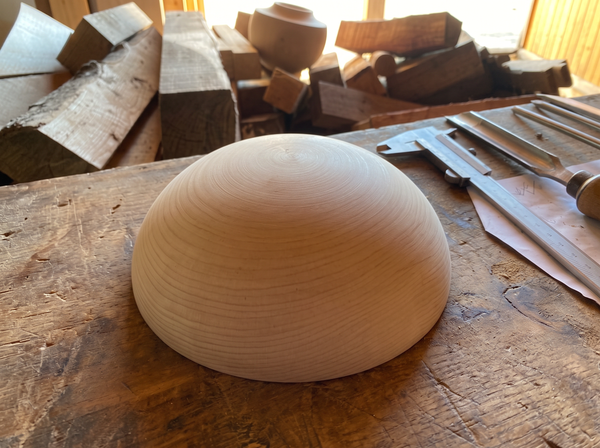 20 cm pine wooden hemisphere, hand-turned, on the workshop bench