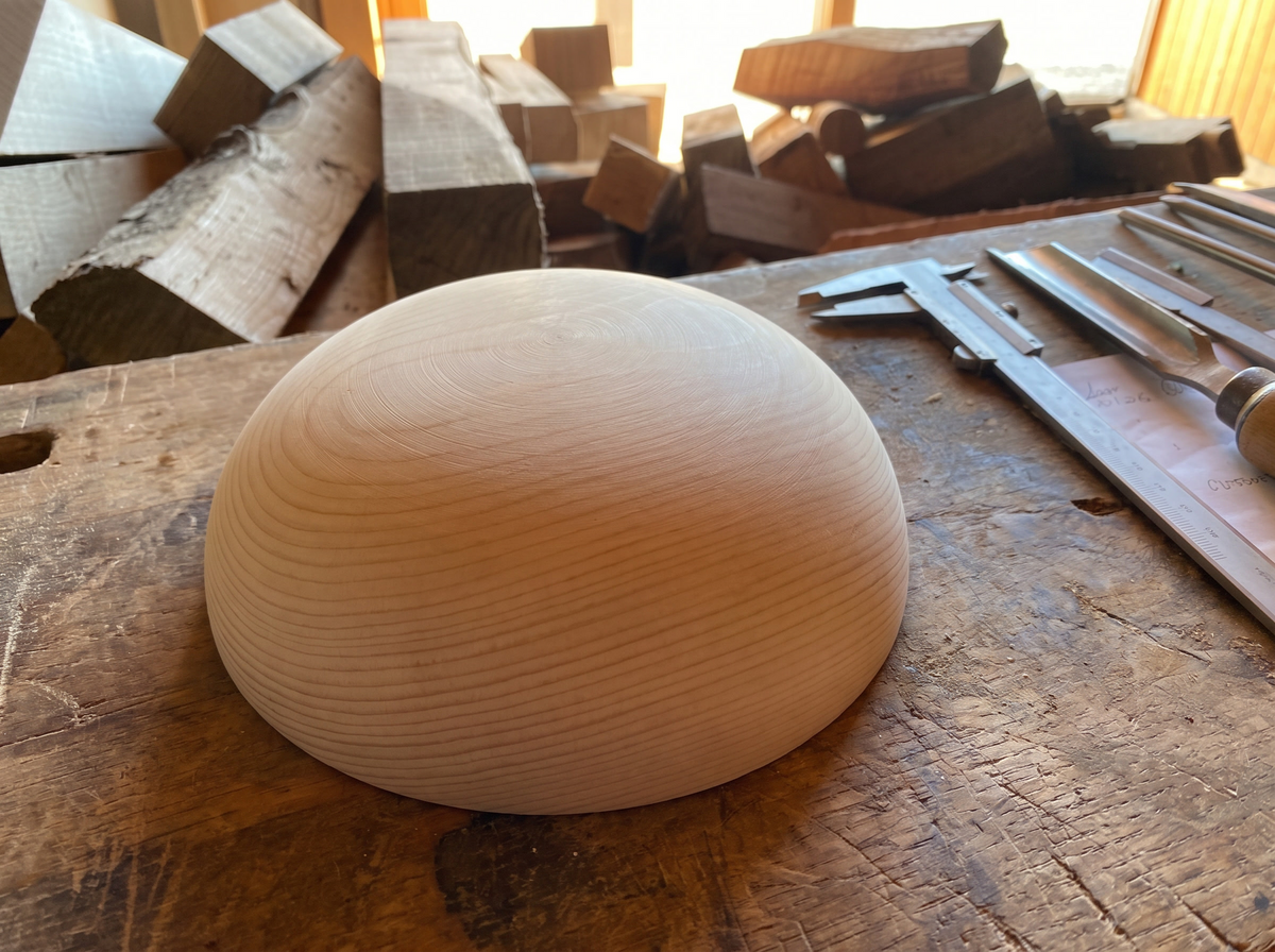 21 cm pine wooden hemisphere, hand-turned, on the workshop bench