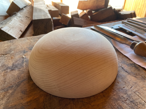 23 cm pine wooden hemisphere, hand-turned, on the workshop bench
