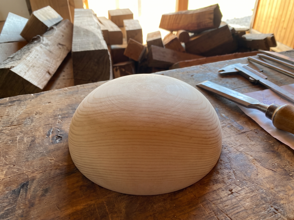 24 cm pine wooden hemisphere, hand-turned, on the workshop bench