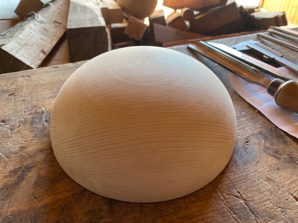 26 cm pine wooden hemisphere, hand-turned, on the workshop bench
