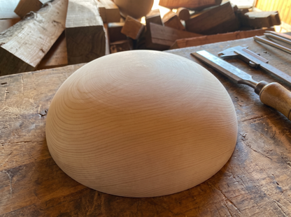 27 cm pine wooden hemisphere, hand-turned, on the workshop bench