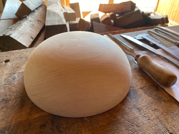 28 cm pine wooden hemisphere, hand-turned, on the workshop bench