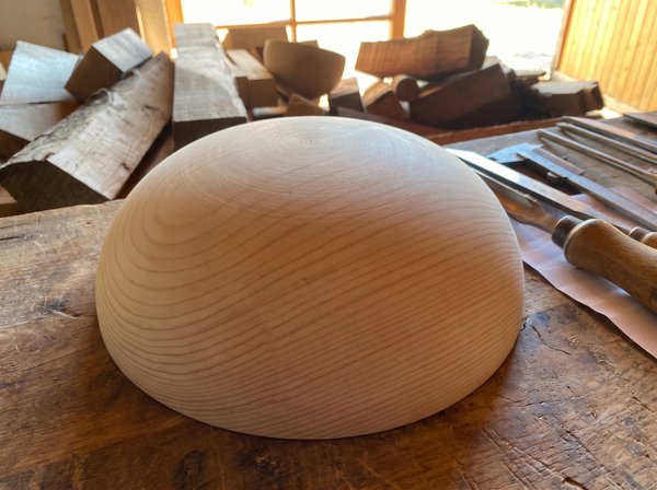 29 cm pine wooden hemisphere, hand-turned, on the workshop bench