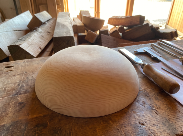 30 cm pine wooden hemisphere, hand-turned, on the workshop bench