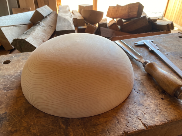 31 cm pine wooden hemisphere, hand-turned, on the workshop bench