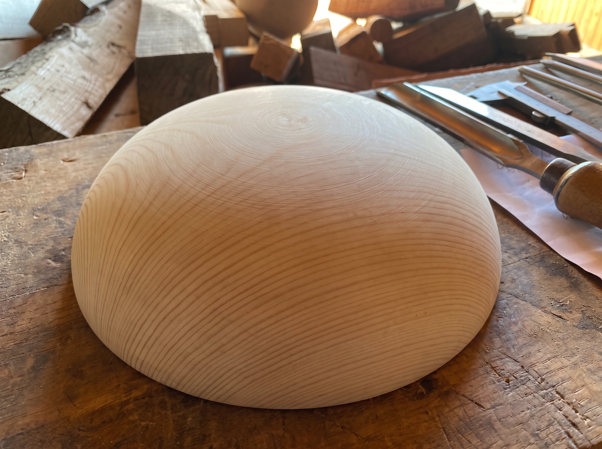 32 cm pine wooden hemisphere, hand-turned, on the workshop bench