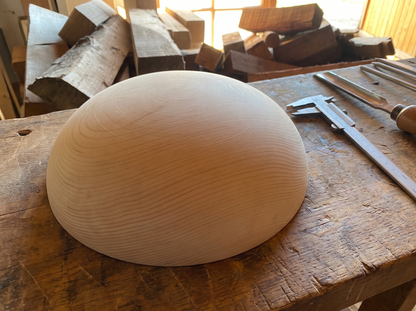 33 cm pine wooden hemisphere, hand-turned, on the workshop bench