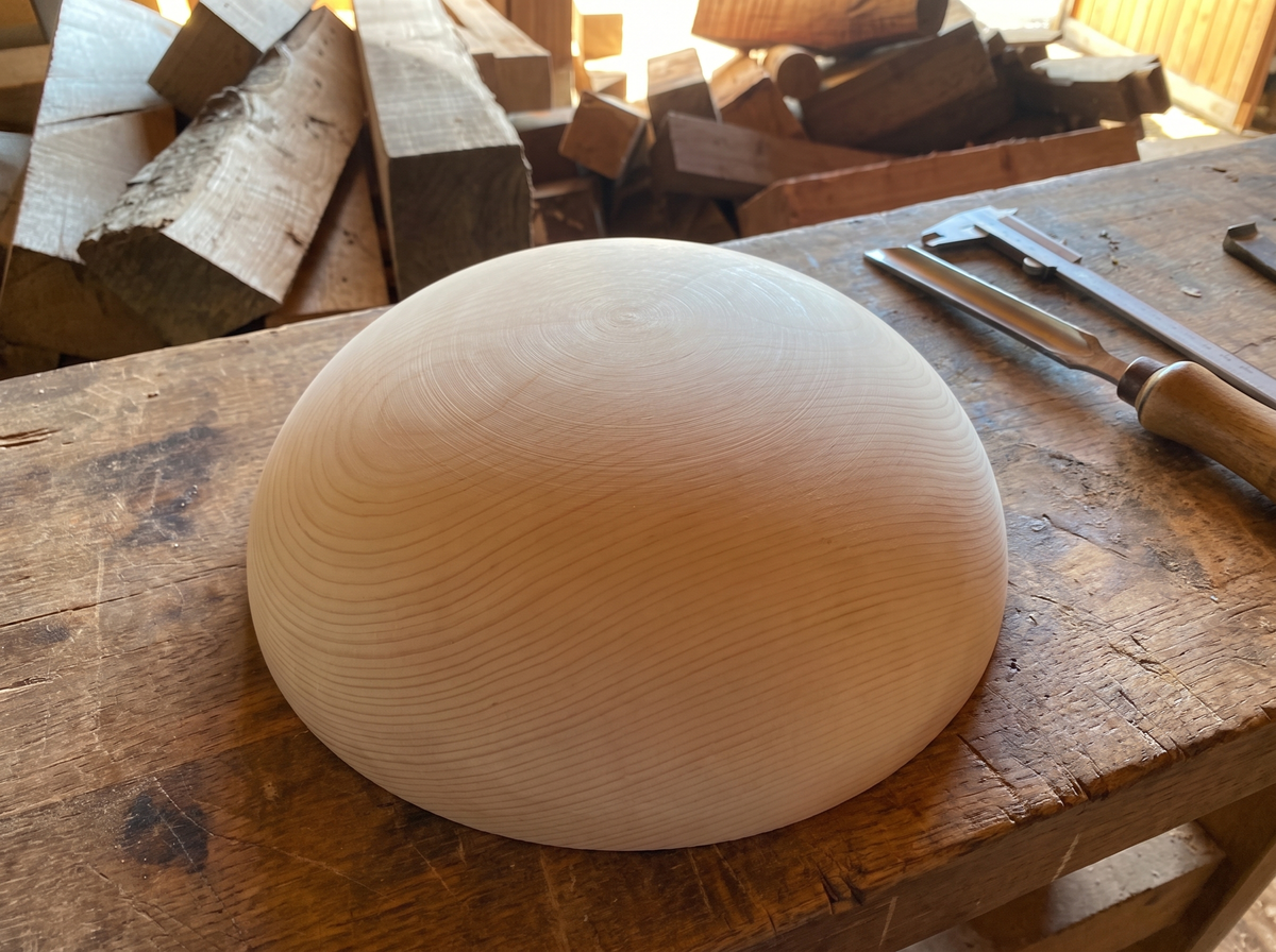 34 cm pine wooden hemisphere, hand-turned, on the workshop bench
