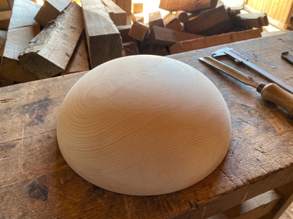 34 cm pine wooden hemisphere, hand-turned, on the workshop bench