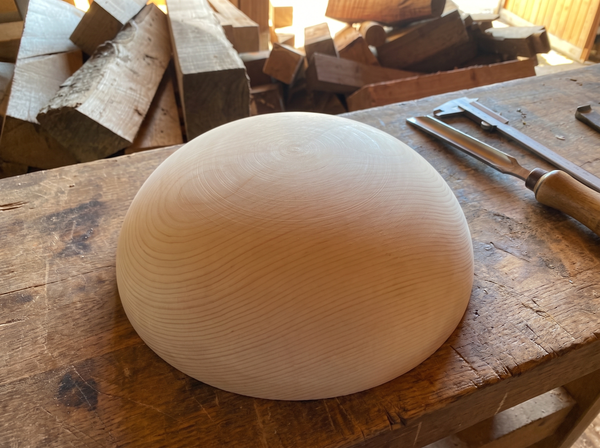 34 cm pine wooden hemisphere, hand-turned, on the workshop bench