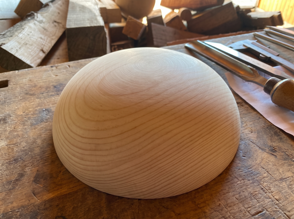35 cm pine wooden hemisphere, hand-turned, on the workshop bench