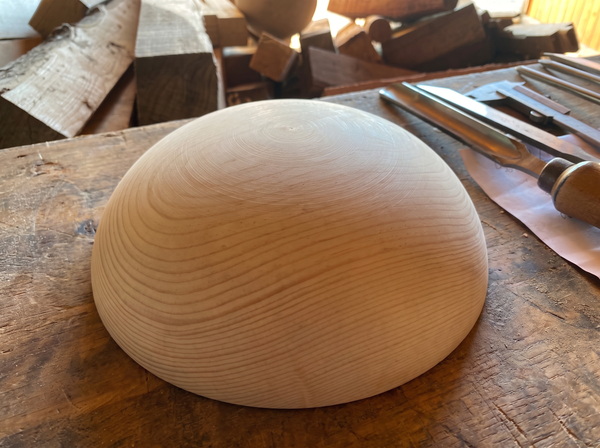 36 cm pine wooden hemisphere, hand-turned, on the workshop bench