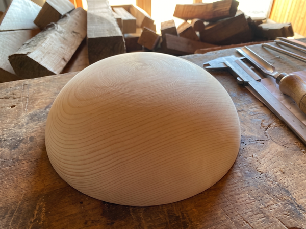 38 cm pine wooden hemisphere, hand-turned, on the workshop bench