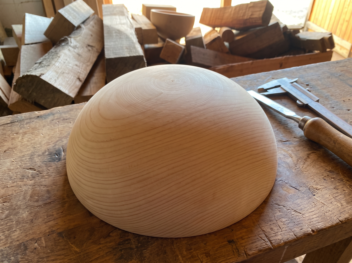 40 cm pine wooden hemisphere, hand-turned, on the workshop bench