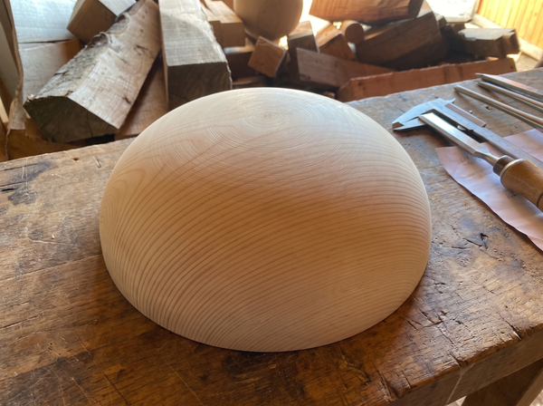 41 cm pine wooden hemisphere, hand-turned, on the workshop bench