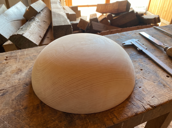 45 cm pine wooden hemisphere, hand-turned, on the workshop bench
