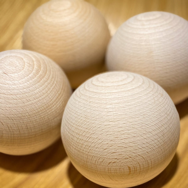 Set of four 90mm beechwood decorative balls, natural finish, UK handcrafted craft spheres